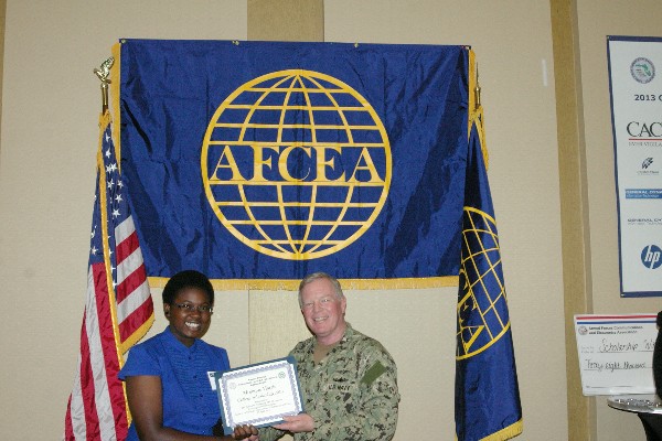 Capt. Slevin presents a STEM Scholarship certificate to a student recipient in April.